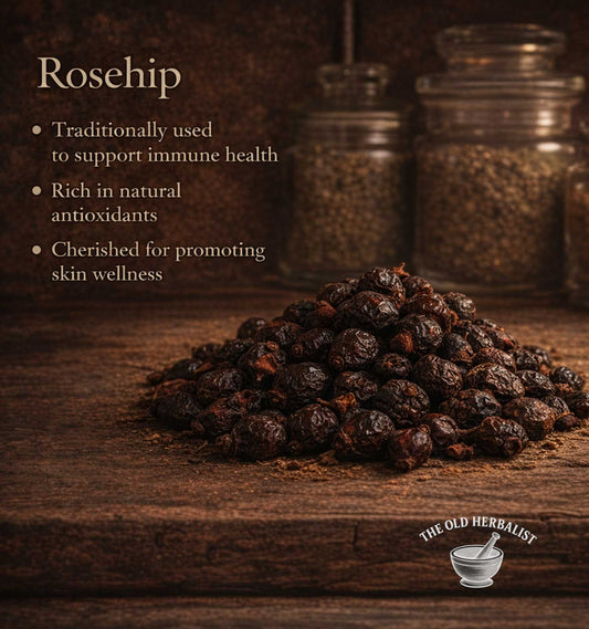 Rosehips on a wooden surface with text about their health benefits and The Old Herbalist logo.