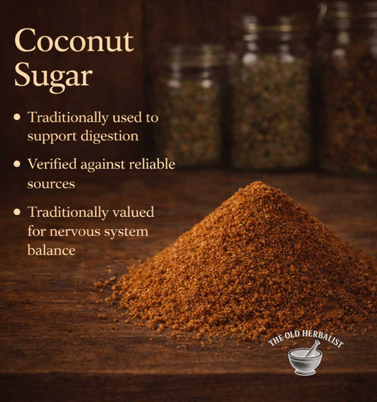 Coconut sugar on a wooden surface with text about its uses and sources, branded by 'The Old Herbalist'.