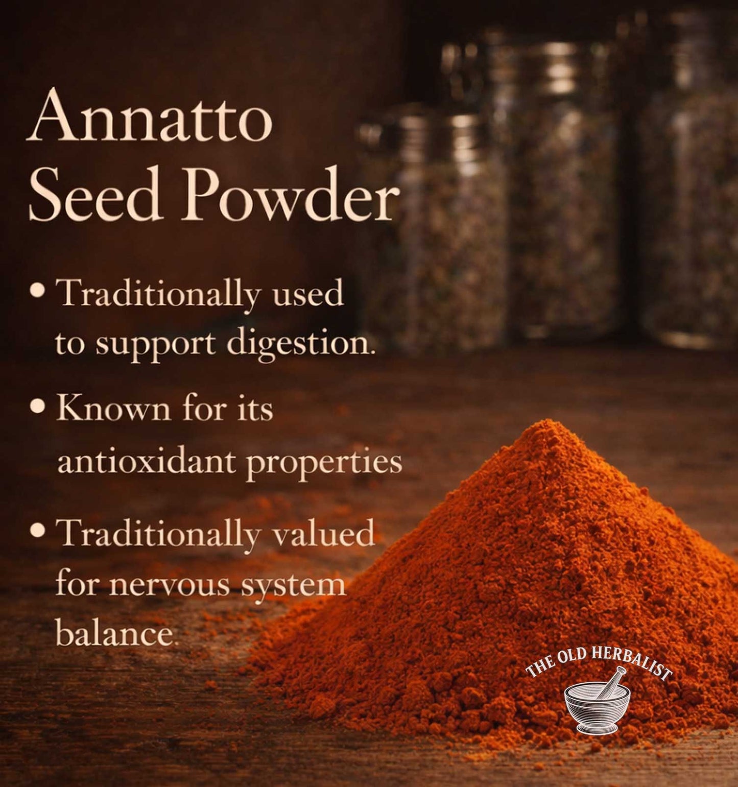 Annatto seed powder with text about its uses on a wooden surface, featuring The Old Herbalist logo.