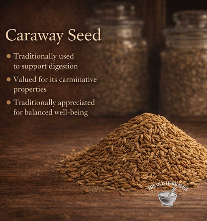 Caraway seed with text about its uses on a wooden surface, featuring The Old Herbalist logo.