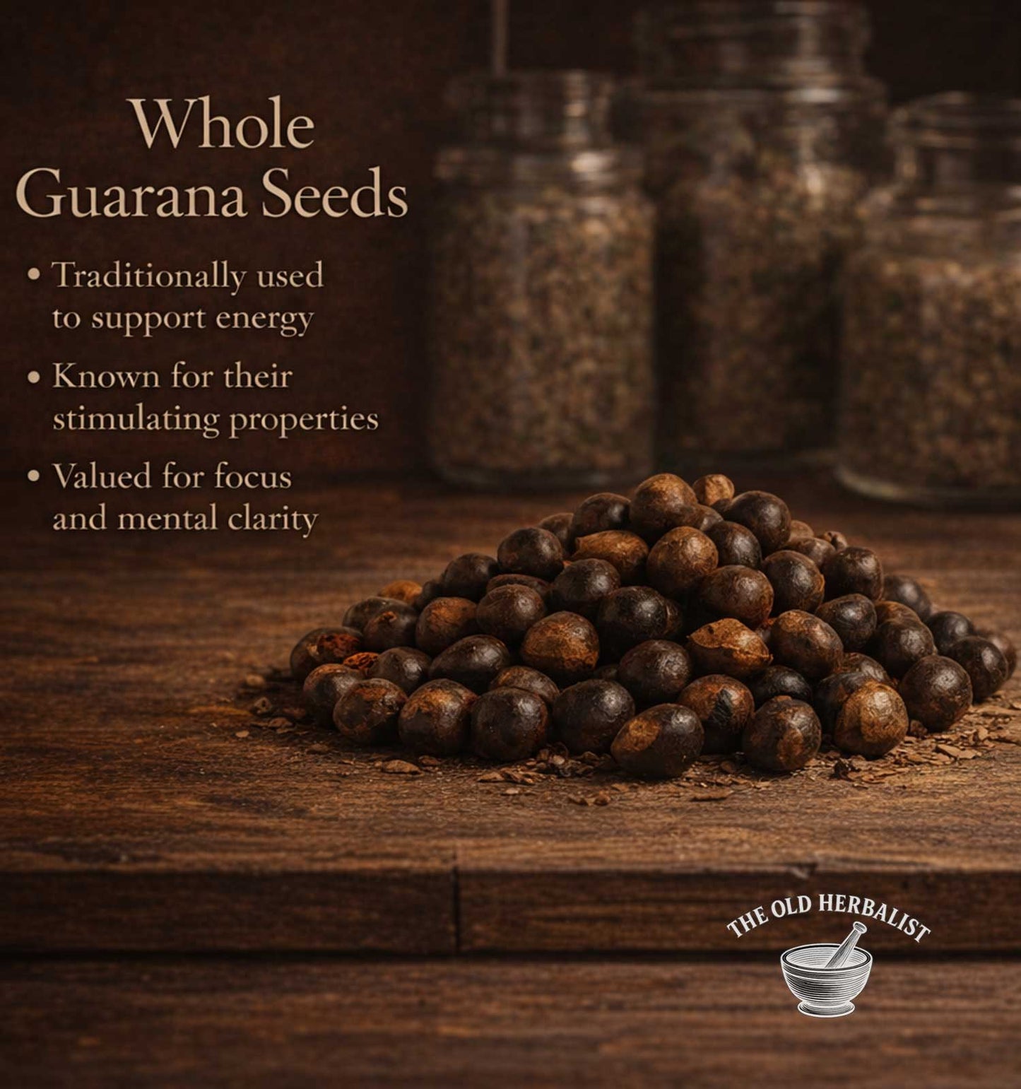 Whole guarana seeds on a wooden surface with text about their uses and The Old Herbalist branding.