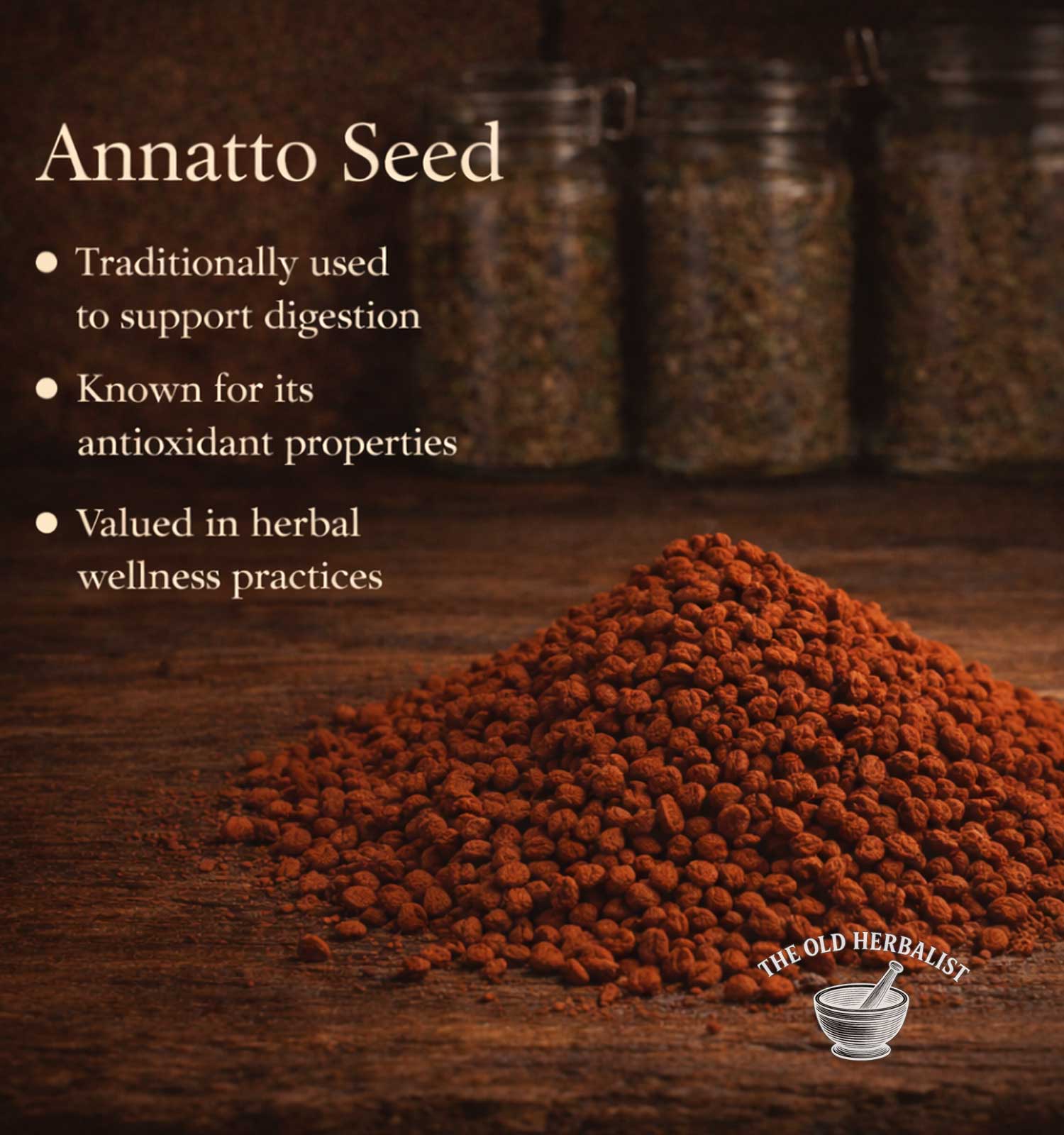 Annatto seed on a wooden surface with text about its uses and The Old Herbalist branding.