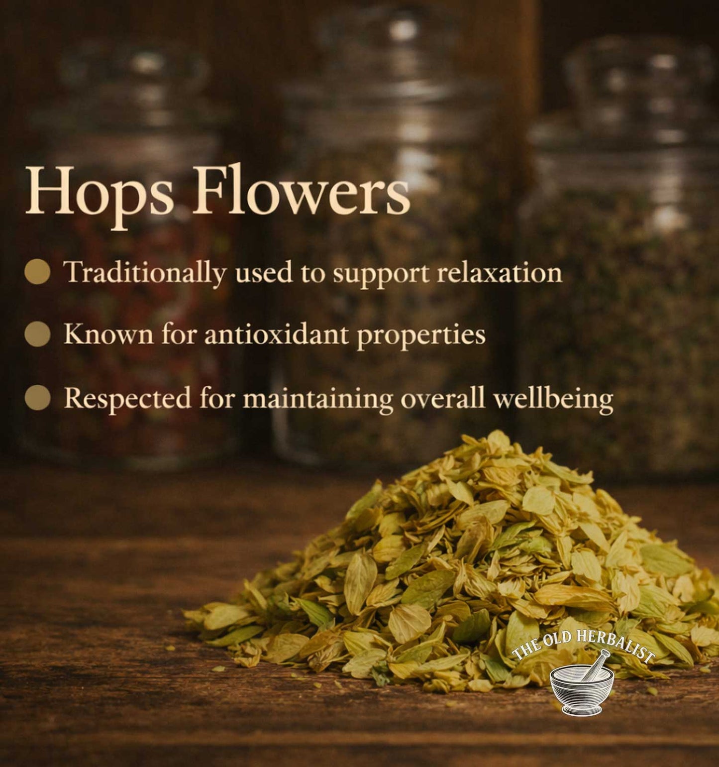 Hops flowers on a wooden surface with text about their uses, set against a blurred background of jars.