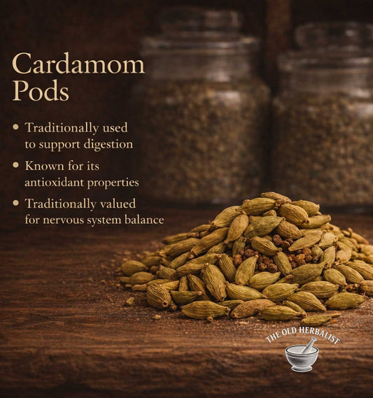 Cardamom pods on a wooden surface with text about their uses and The Old Herbalist logo.