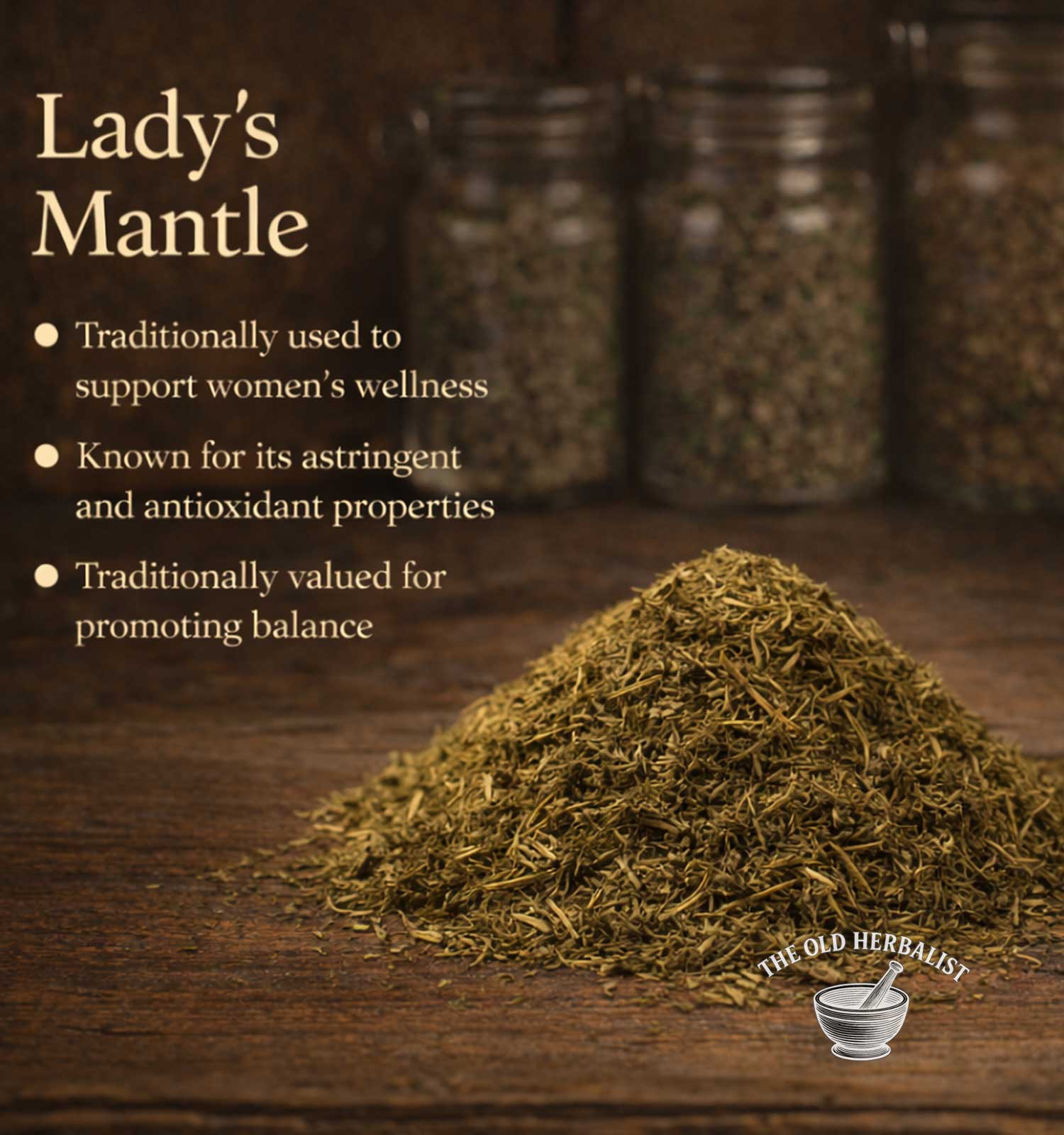 Heap of Lady's Mantle on a wooden surface with text about its uses and The Old Herbalist branding.