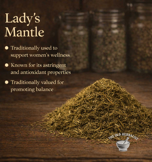 Heap of Lady's Mantle on a wooden surface with text about its uses and The Old Herbalist branding.