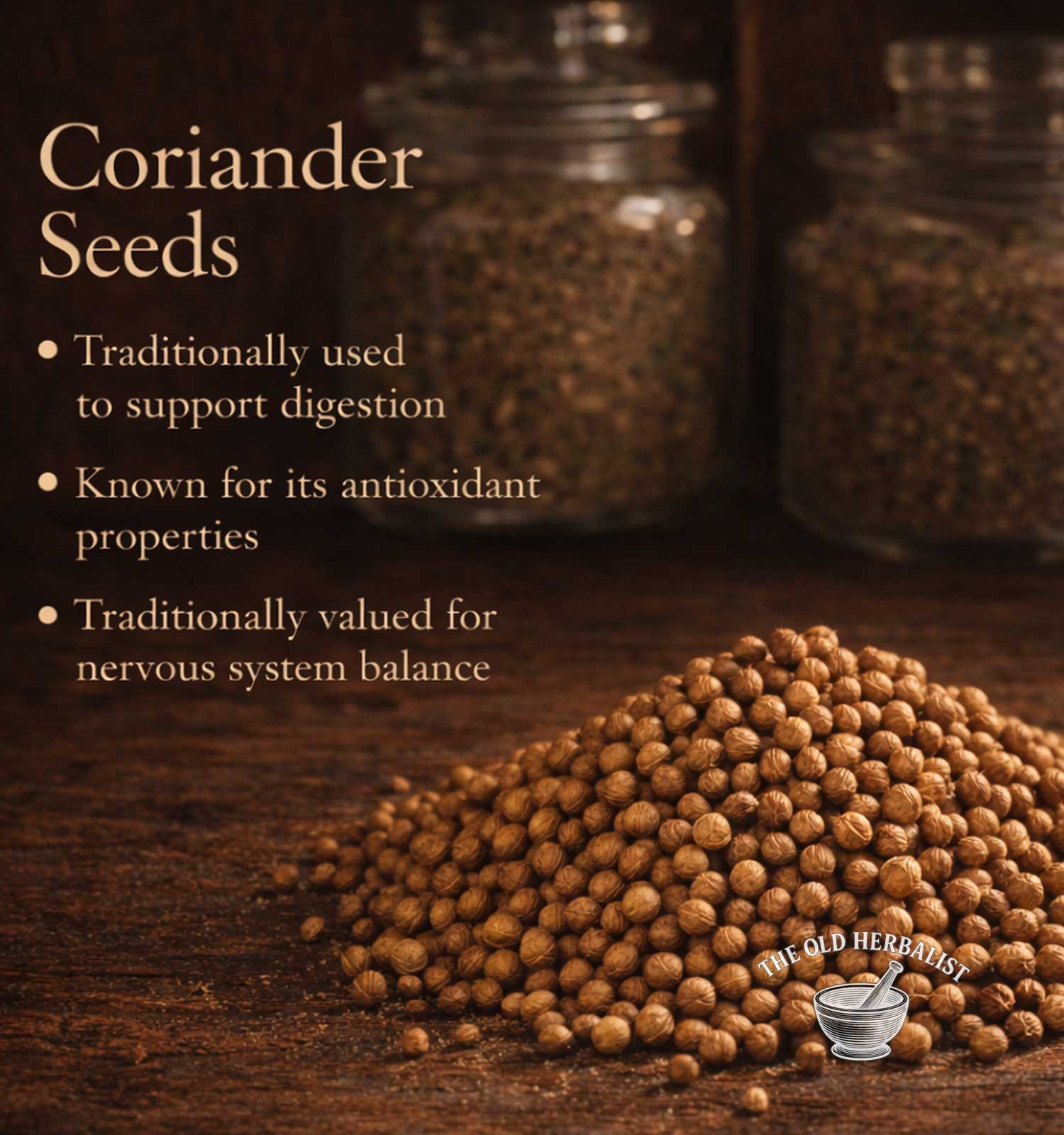 Coriander seeds on a wooden surface with text about their uses and The Old Herbalist branding.