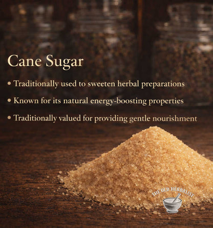 Cane sugar on a wooden surface with text about its uses and properties, branded 'The Old Herbalist'.