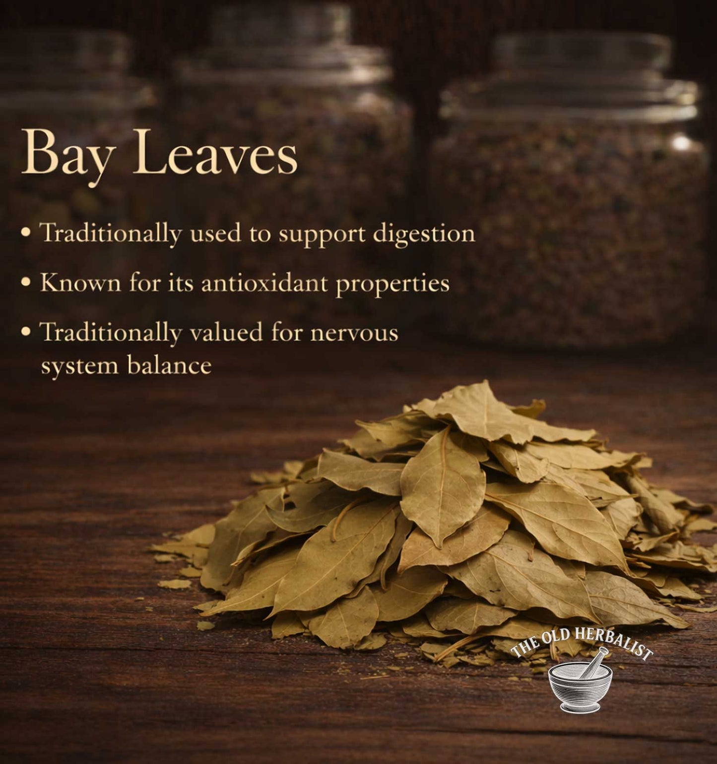 Bay leaves on a wooden surface with text about their uses, set against jars in the background.