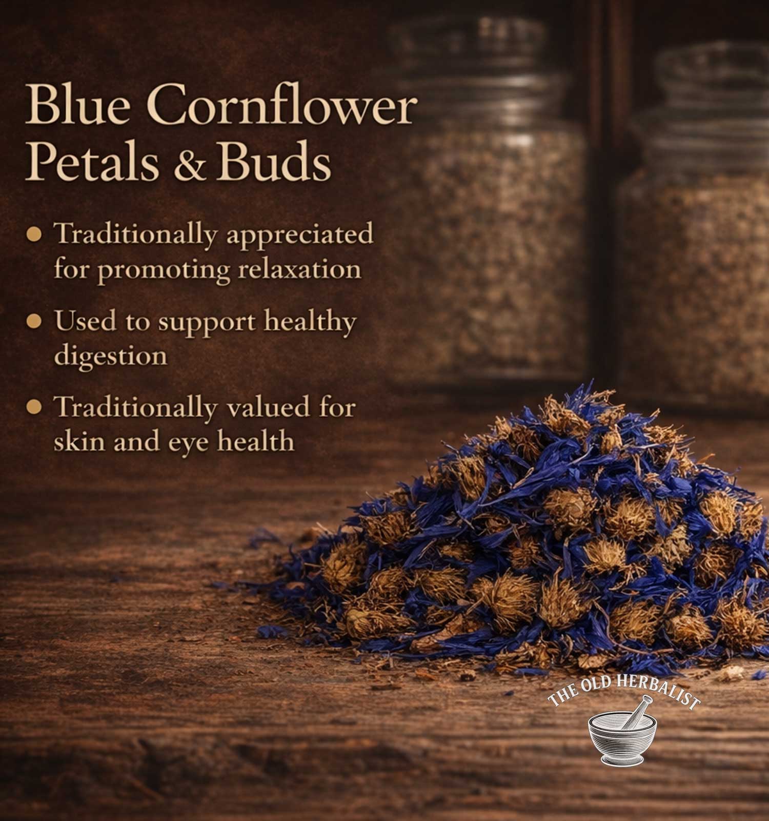 Blue cornflower petals and buds with text about their traditional uses on a wooden surface, featuring The Old Herbalist logo.