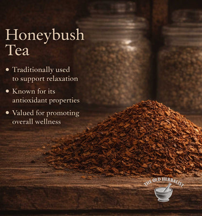 Honeybush tea leaves on a wooden surface with text about its benefits and The Old Herbalist branding.